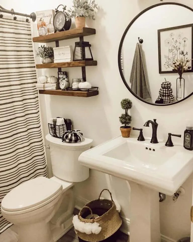 Black mirror and pedestal sink