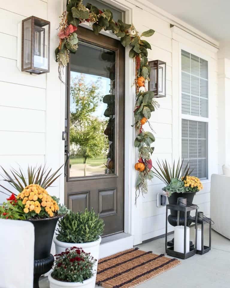 Black planters with fall greenery