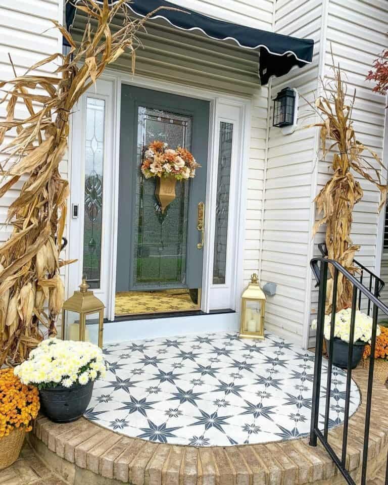 Brass lanterns with mums and corn stalks