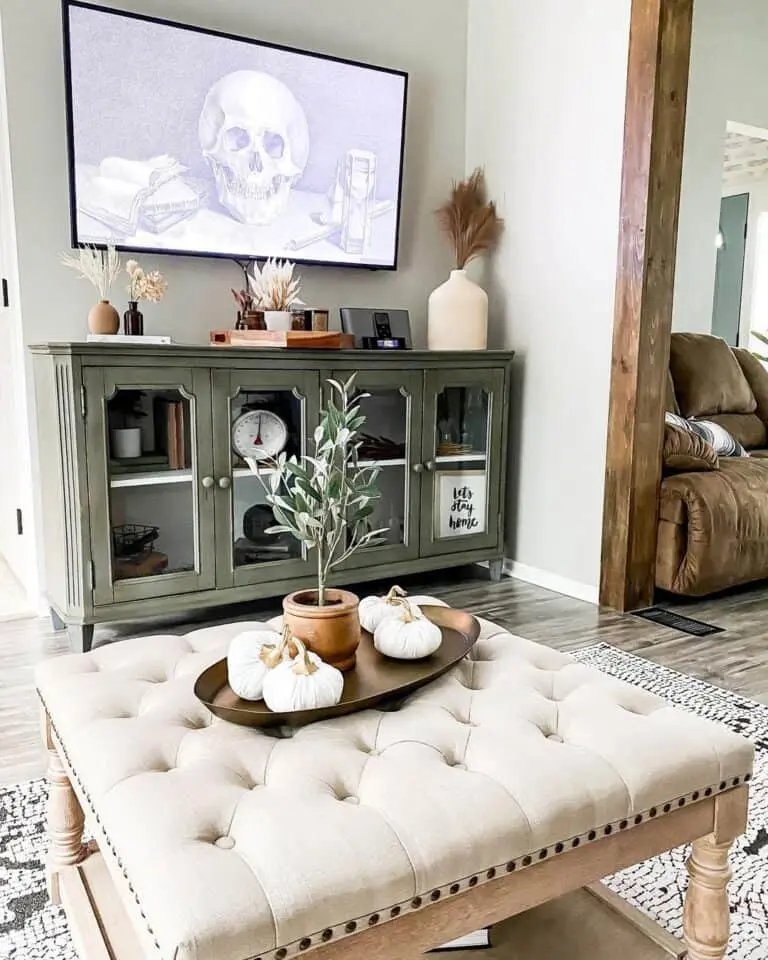 Cream ottoman with fall centerpiece
