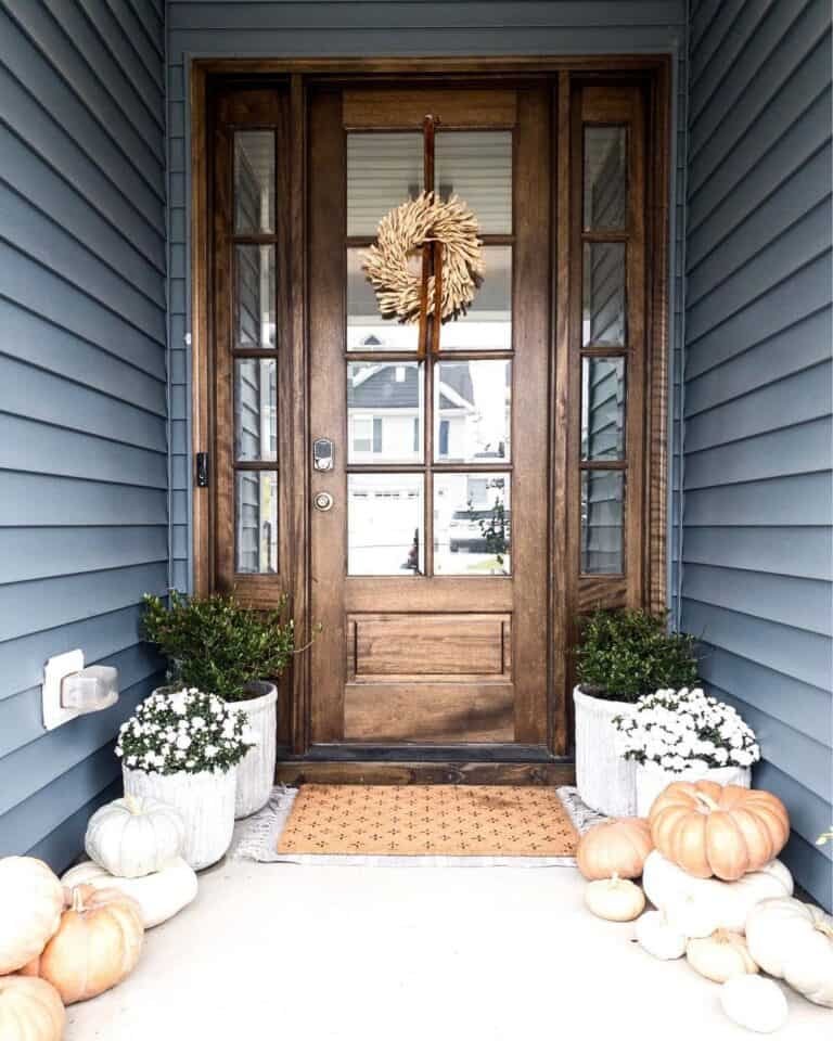 Dark blue exterior with wood door and pumpkins