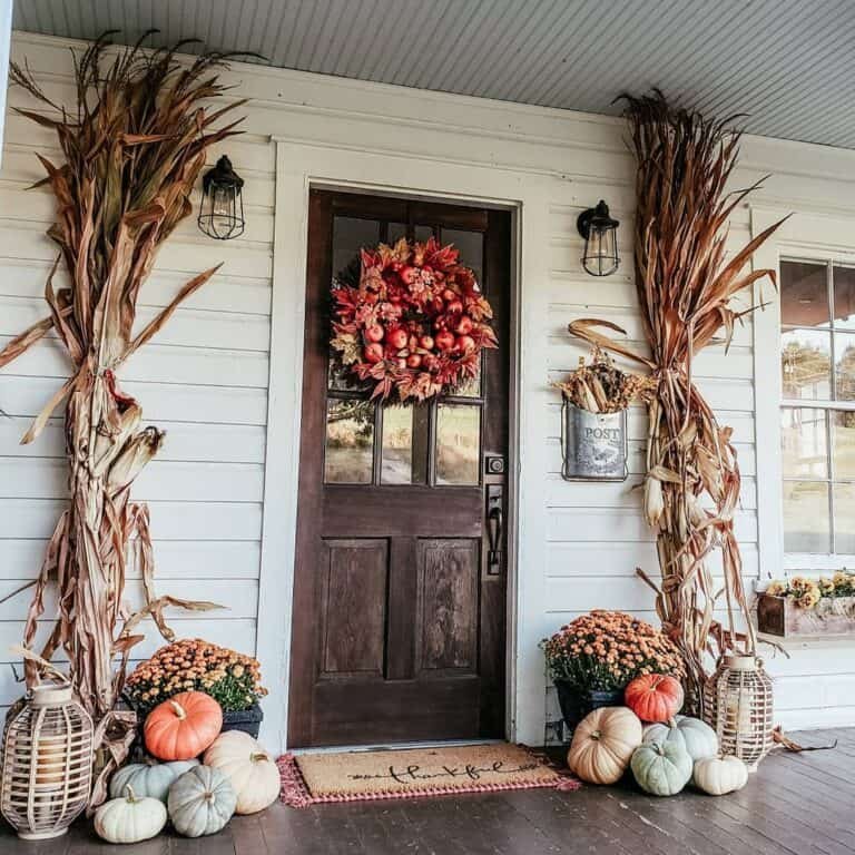 Dark wood door with autumn wreath and pumpkins