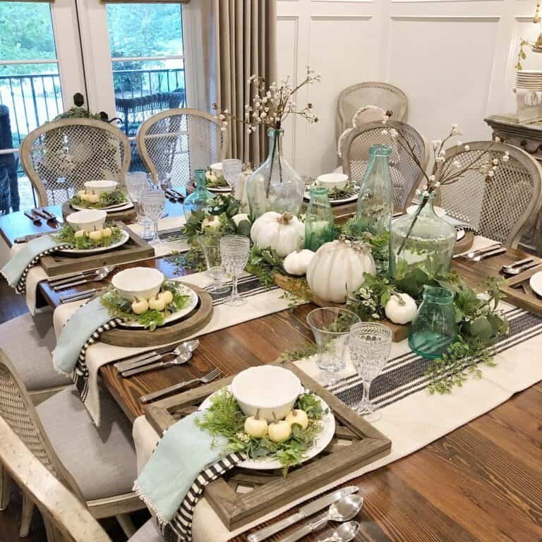 Green foliage, white pumpkins
