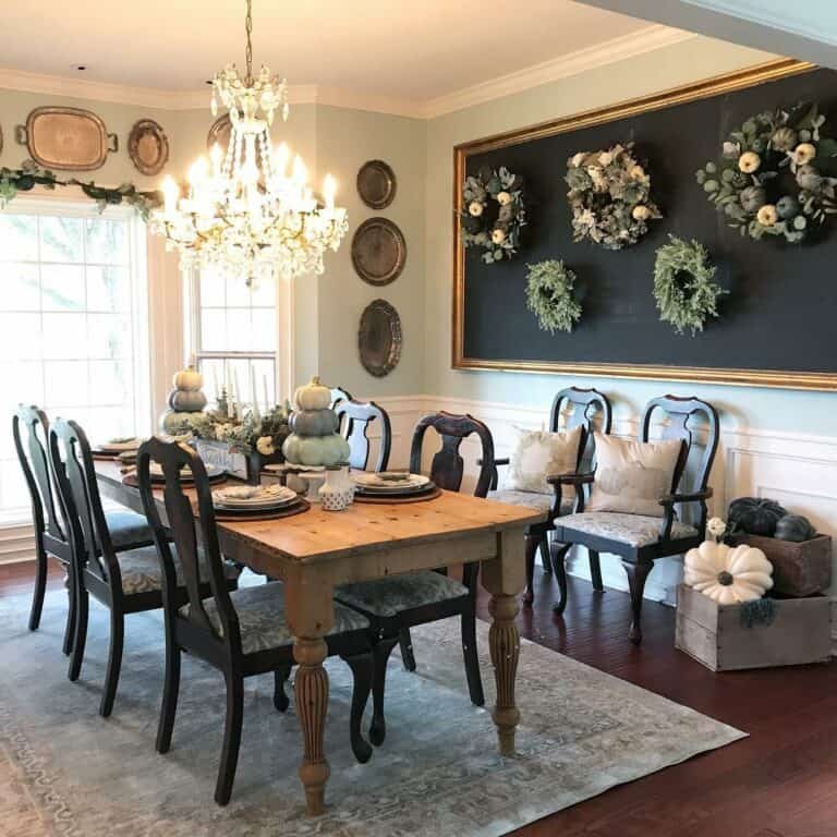 Green wreaths with gourds on chalkboard wall