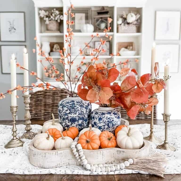 Mini pumpkins, leaves, brass candles