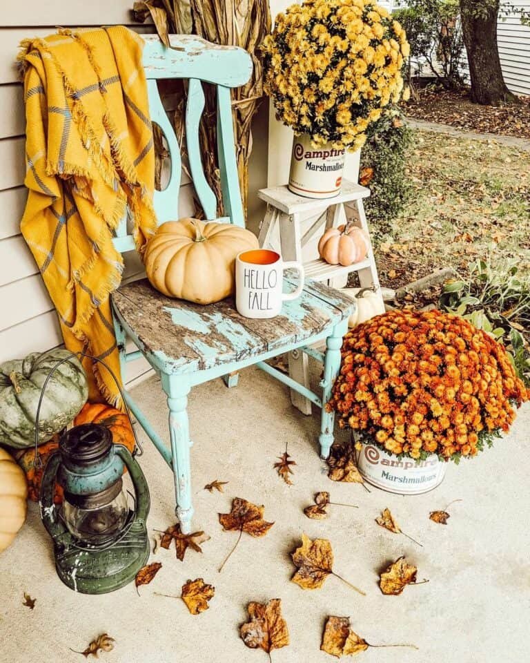 Mounding mums, rustic chair, pumpkin, lantern