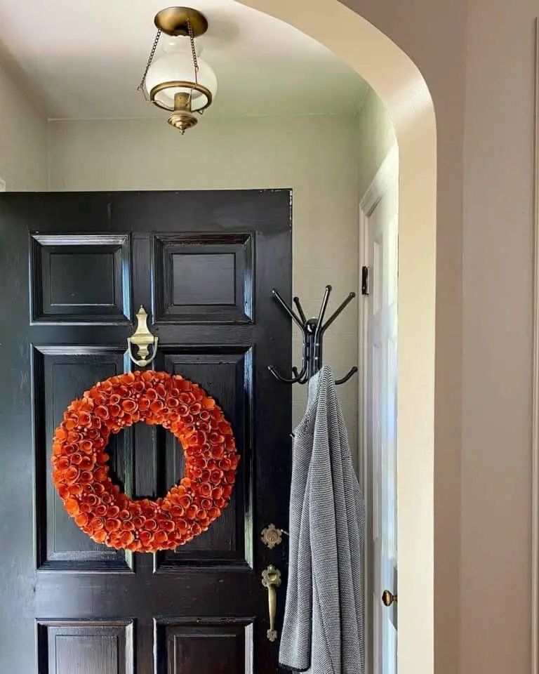 Orange wreath on dark door