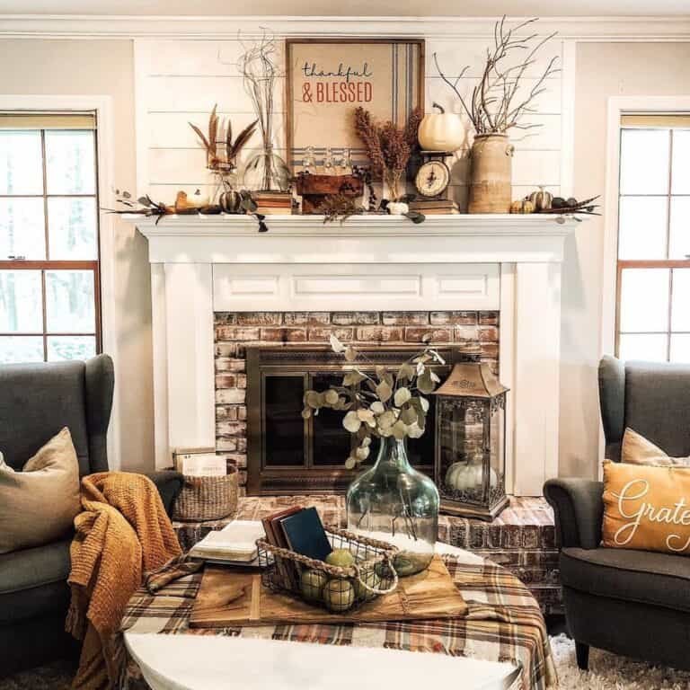 Pumpkins and leaves on white mantel