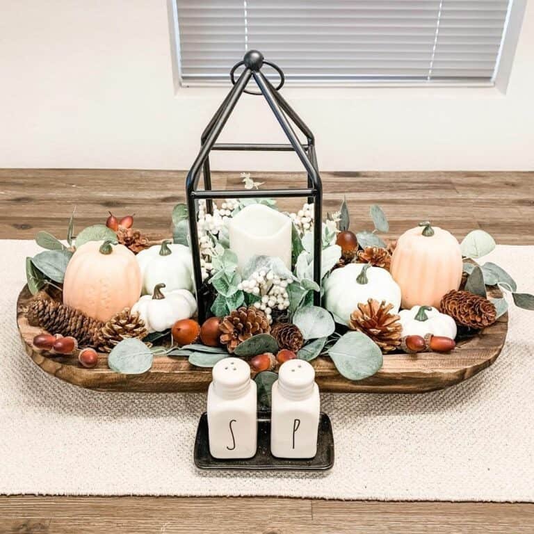 Rustic fall lantern with pumpkins and pinecones