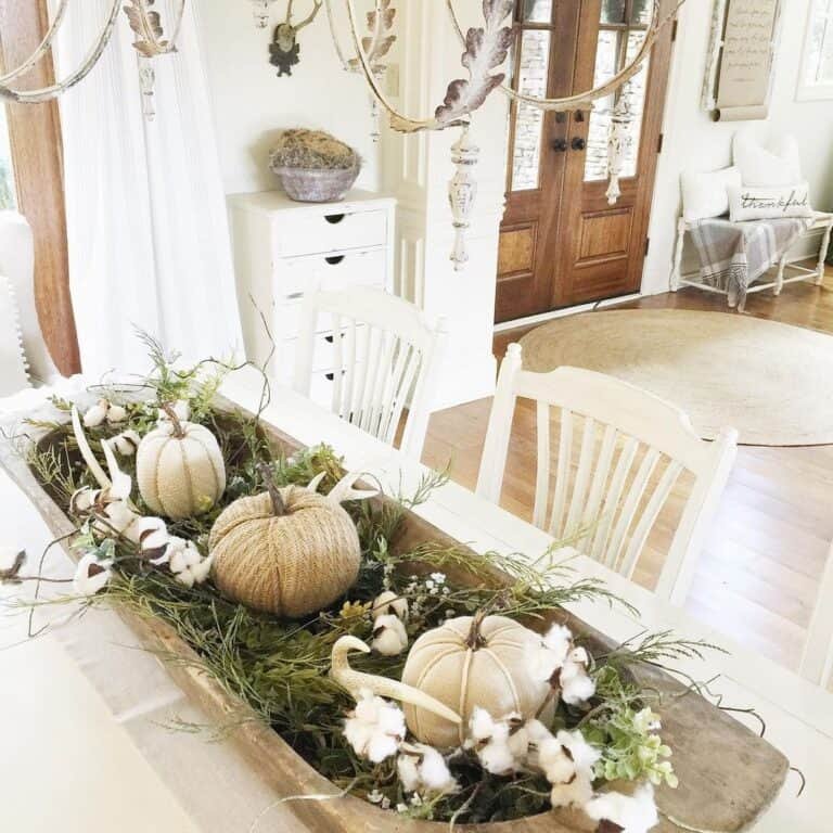 Rustic wooden tray with neutral pumpkins