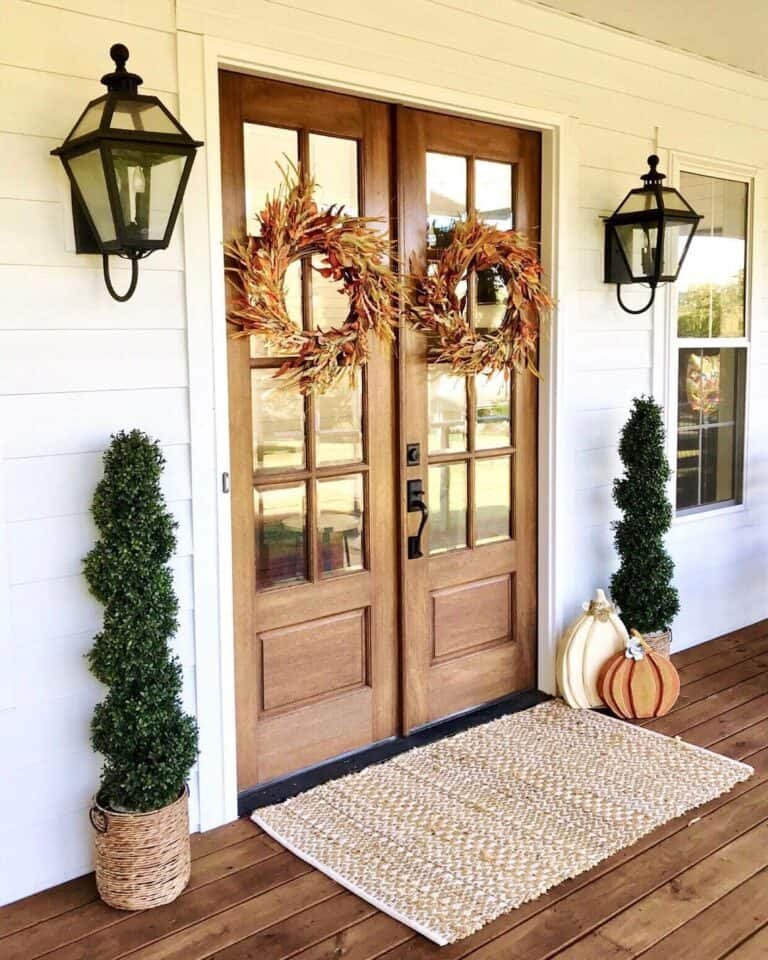 White Home with Wood French Doors and Fall Wreaths