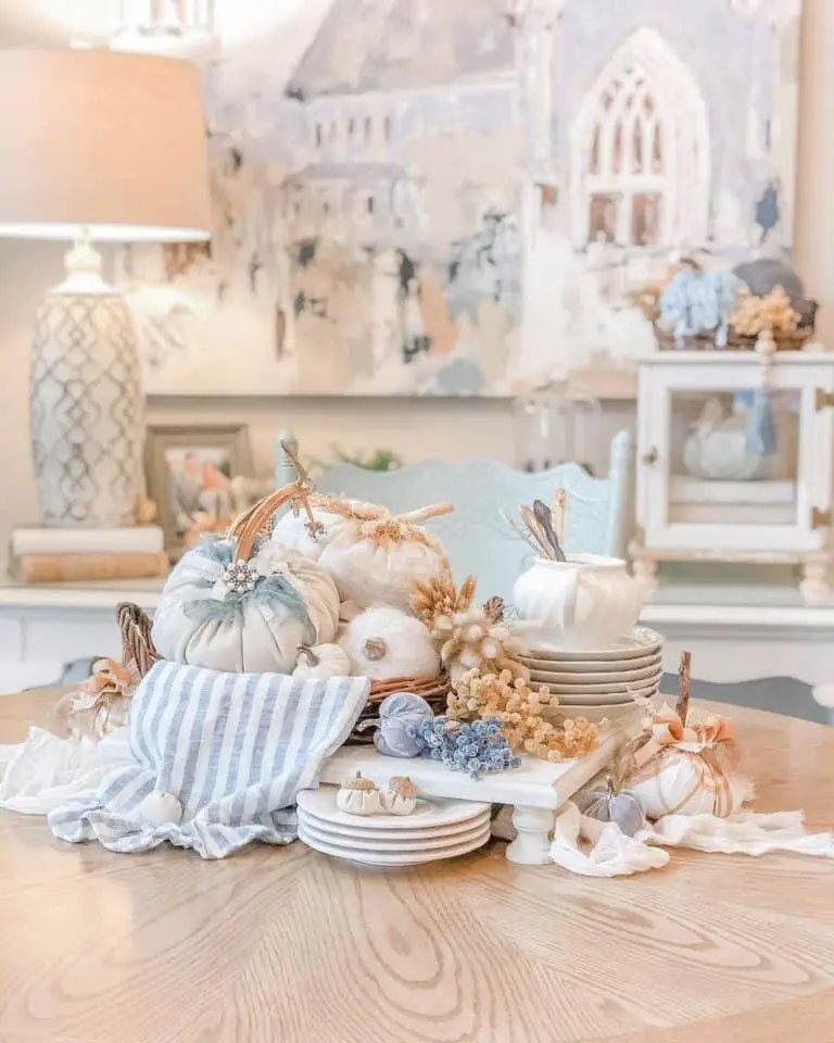 White pumpkins, blue cloth, wicker basket