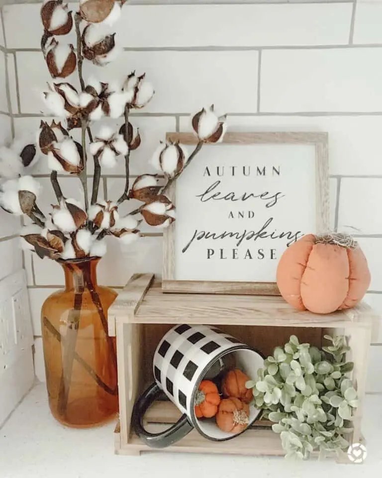 Wooden crate with pumpkins and fall greens
